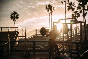 Man exercising with weights in an outdoor gym