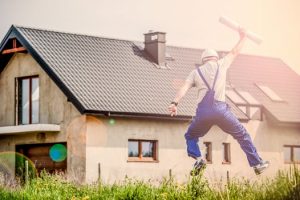 Man jumping for joy outside home that he has implemented condensation solutions