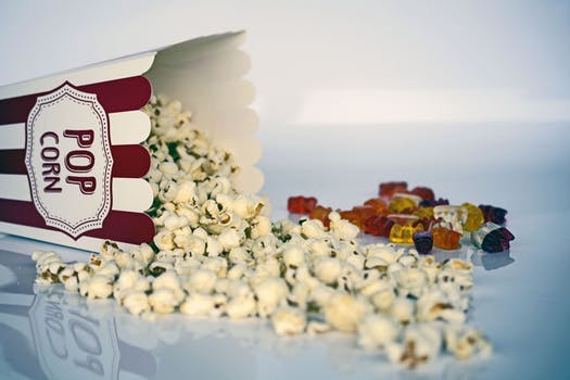 Popcorn in traditional tub poured on table at UK study